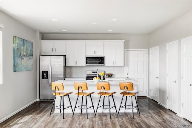 5099 S Robb St, Littleton, CO 80127 - kitchen featuring appliances with stainless steel finishes, tasteful backsplash, dark wood finished floors, light countertops, and recessed lighting