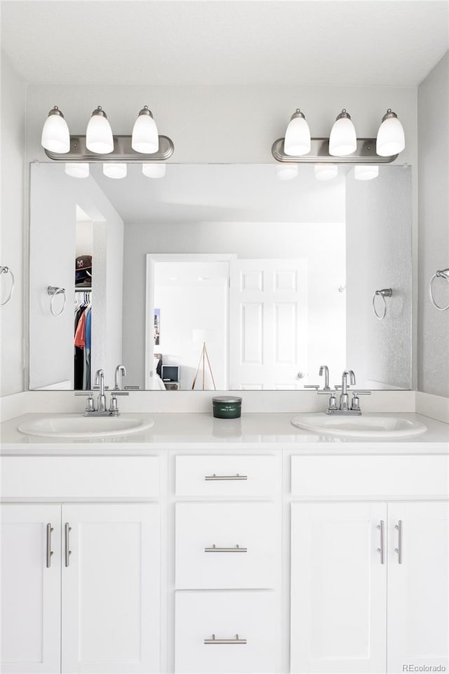5099 S Robb St, Littleton, CO 80127 - full bathroom with double vanity and a spacious closet