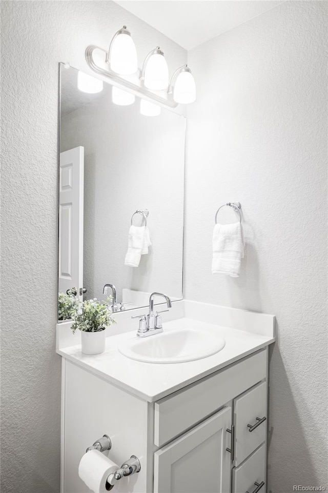 5099 S Robb St, Littleton, CO 80127 - bathroom with vanity and a textured wall