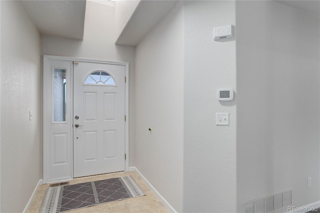 foyer with light tile patterned flooring