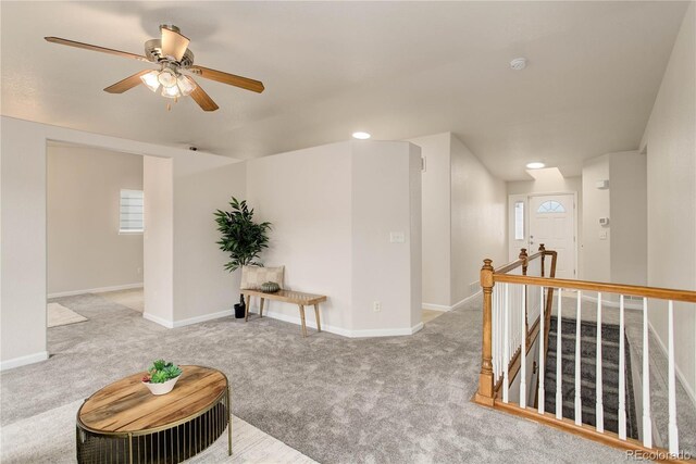 interior space featuring carpet floors, a healthy amount of sunlight, and ceiling fan