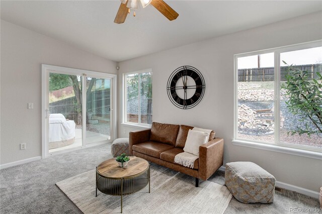 living room with a healthy amount of sunlight, light carpet, and ceiling fan