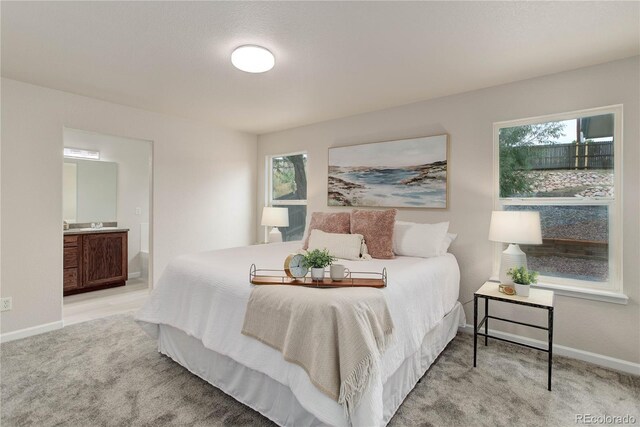 carpeted bedroom featuring connected bathroom