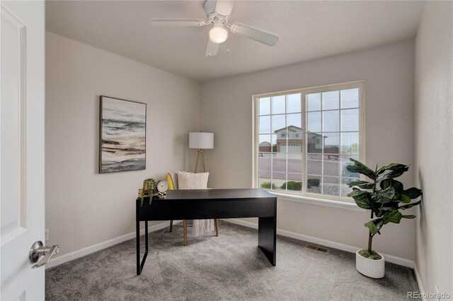 carpeted home office with ceiling fan