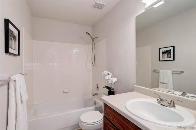 full bathroom with bathtub / shower combination, vanity, and toilet