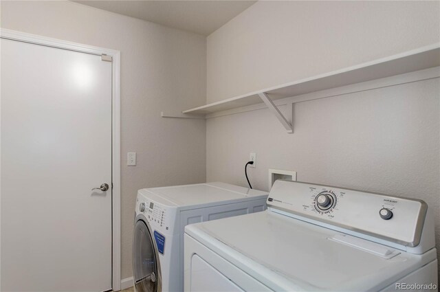 clothes washing area featuring washing machine and clothes dryer