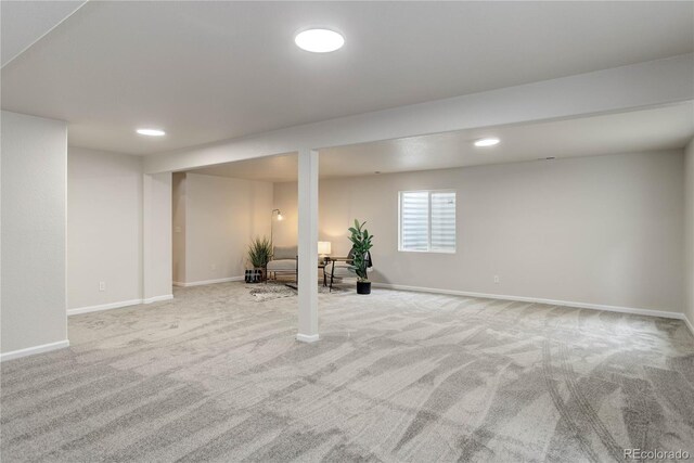 basement featuring light colored carpet