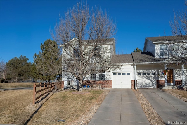 view of front facade with a garage and a front lawn