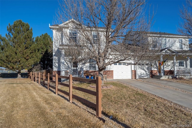 view of front of home with a garage and a front lawn