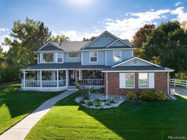 view of front facade with a front yard and covered porch