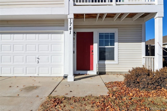 entrance to property with a balcony and a garage