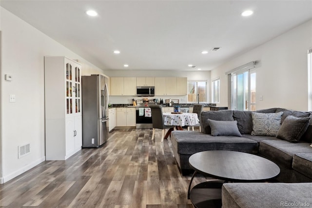 living room with dark hardwood / wood-style flooring