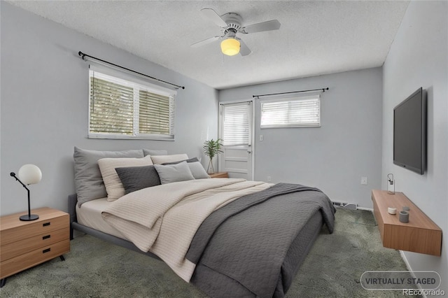 bedroom with dark carpet, a textured ceiling, and ceiling fan