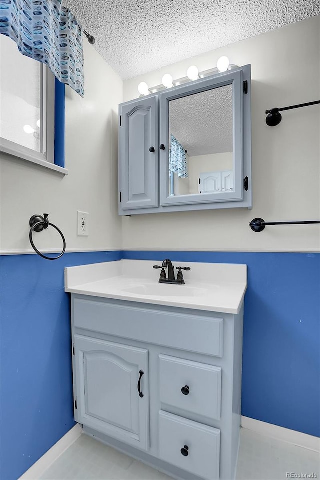 bathroom with vanity and a textured ceiling