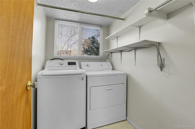 washroom with separate washer and dryer and a textured ceiling