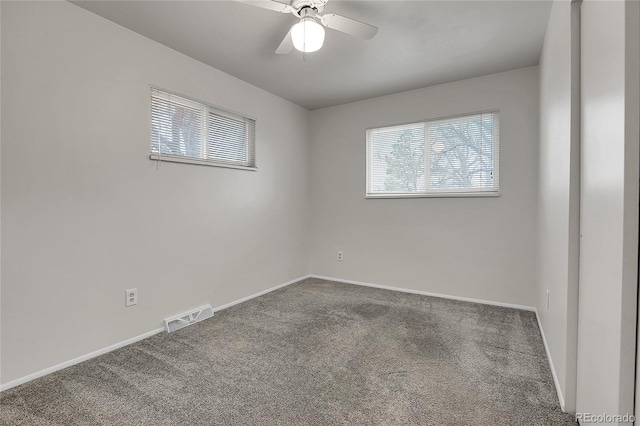 unfurnished room featuring carpet floors, a ceiling fan, visible vents, and baseboards