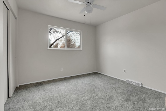 unfurnished bedroom with baseboards, visible vents, a ceiling fan, carpet floors, and a closet