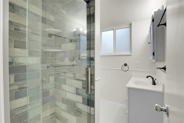 full bathroom featuring a stall shower and vanity