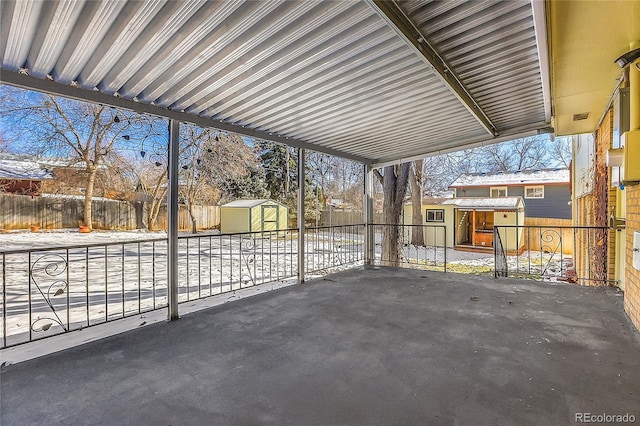 view of patio with a shed, a fenced backyard, and an outdoor structure