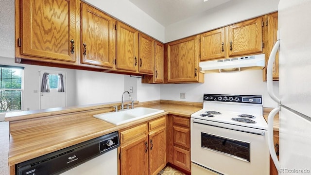 6796 S Independence St, Littleton, CO 80128 - kitchen with white appliances, under cabinet range hood, light countertops, and brown cabinets