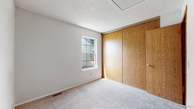 6796 S Independence St, Littleton, CO 80128 - unfurnished bedroom featuring carpet floors, a textured ceiling, and a closet