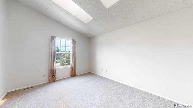6796 S Independence St, Littleton, CO 80128 - unfurnished room featuring a skylight, light carpet, a textured ceiling, and vaulted ceiling