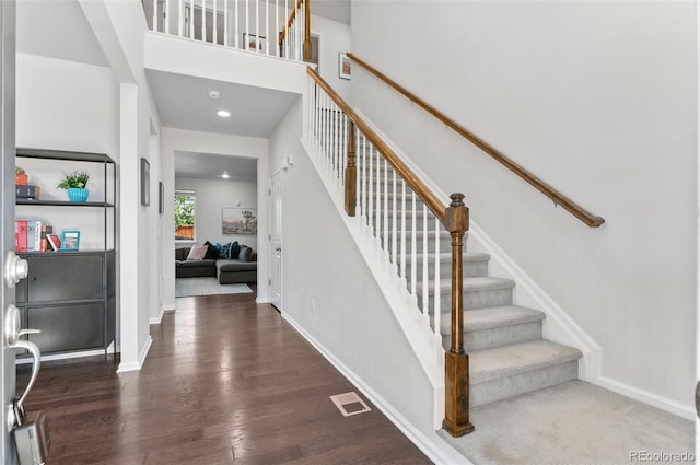 entrance foyer with stairs, wood finished floors, baseboards, and recessed lighting