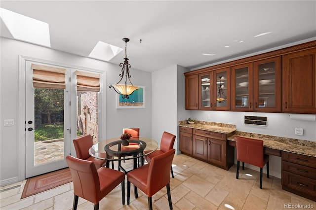 dining room featuring a skylight and built in desk