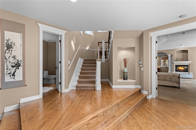 stairs with hardwood / wood-style flooring