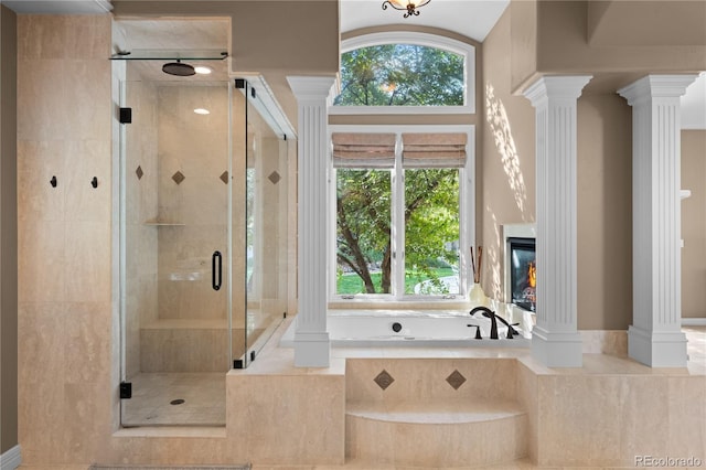 bathroom with shower with separate bathtub and ornate columns