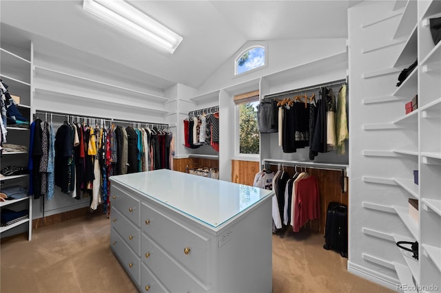 spacious closet with vaulted ceiling and light carpet