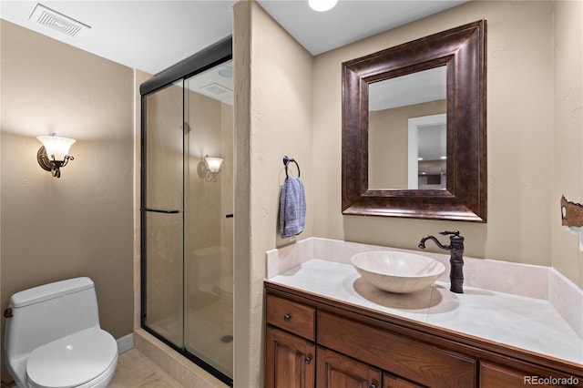 bathroom with vanity, a shower with door, and toilet