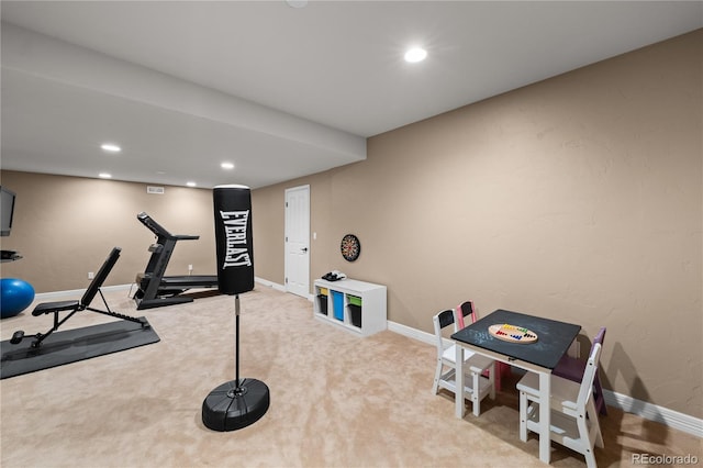 exercise room with light colored carpet