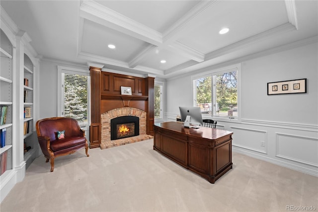 office space with coffered ceiling, a fireplace, ornamental molding, light carpet, and beamed ceiling