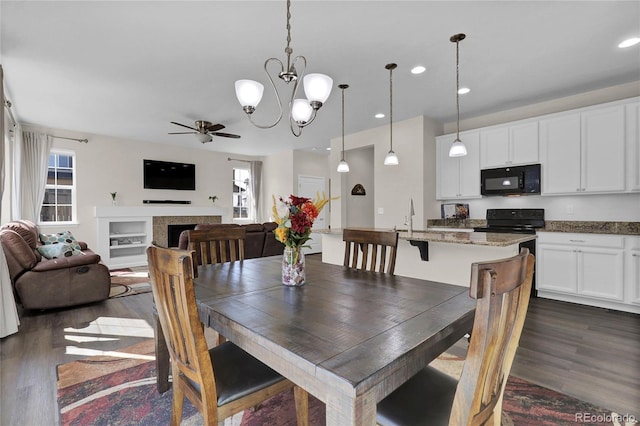 3266 Riverwood Way, Castle Rock, CO 80109 - dining space featuring dark wood-type flooring, ceiling fan with notable chandelier, and a healthy amount of sunlight