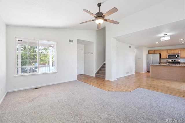 9905 Aftonwood St, Highlands Ranch, CO 80126 - unfurnished living room featuring light colored carpet, vaulted ceiling, stairs, ceiling fan, and recessed lighting