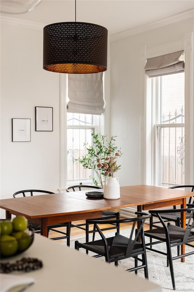 dining area featuring crown molding and wood finished floors