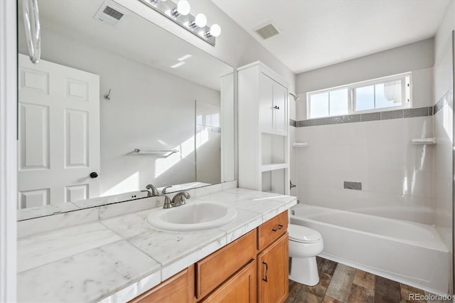 16351 E 104th Pl, Commerce City, CO 80022 - bathroom featuring toilet, vanity, wood finished floors, and shower / bath combination