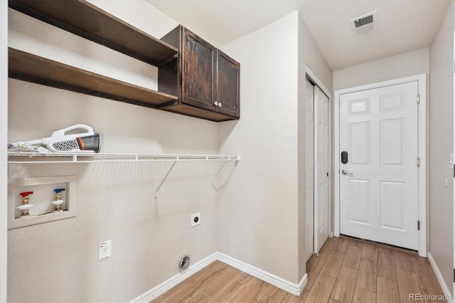 16351 E 104th Pl, Commerce City, CO 80022 - clothes washing area with cabinet space, hookup for an electric dryer, light wood-style flooring, washer hookup, and baseboards