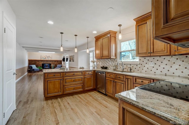 kitchen with pendant lighting, dishwasher, light hardwood / wood-style floors, sink, and kitchen peninsula