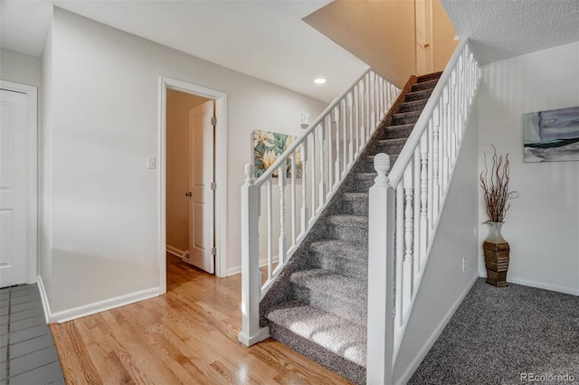 staircase featuring hardwood / wood-style floors