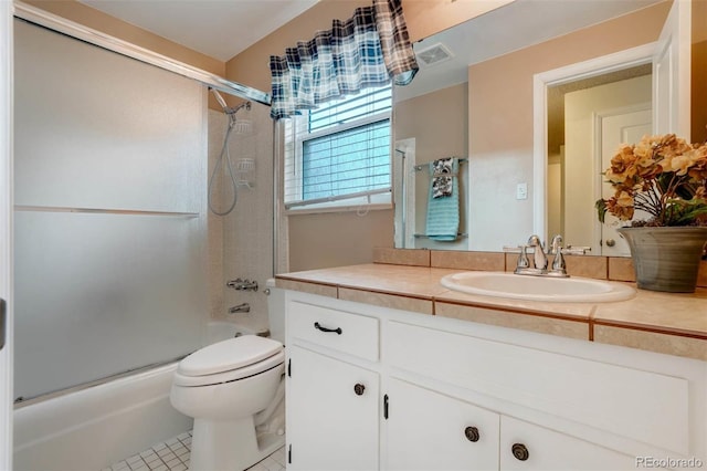 full bathroom featuring toilet, combined bath / shower with glass door, tile patterned flooring, and vanity