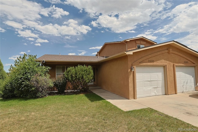 view of front of house with a garage and a front lawn