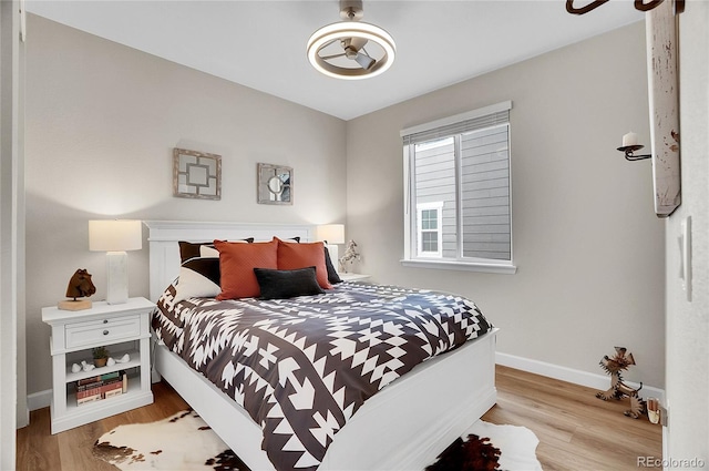 bedroom with light wood-style flooring and baseboards