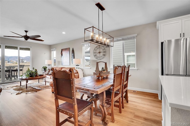 dining area featuring visible vents, ceiling fan with notable chandelier, recessed lighting, light wood finished floors, and baseboards