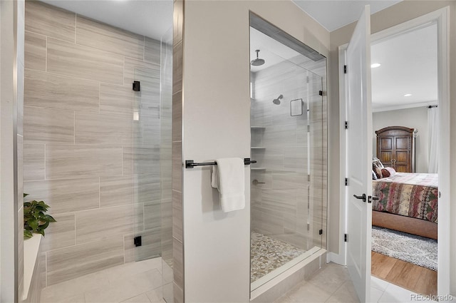 ensuite bathroom with tile patterned flooring, connected bathroom, a stall shower, and ornamental molding