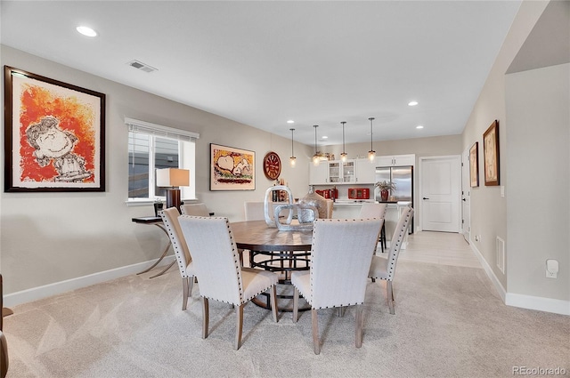 dining space with recessed lighting, visible vents, and light carpet