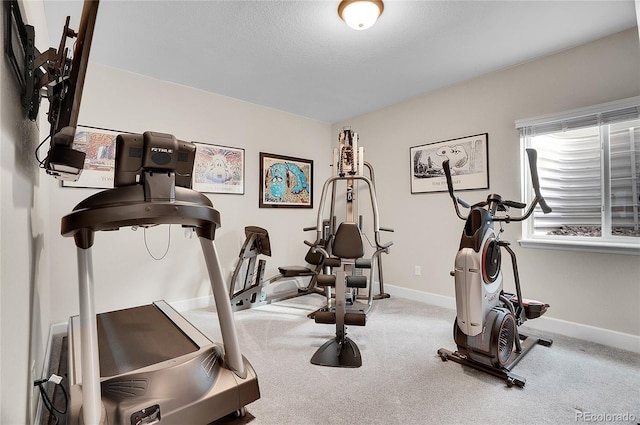 workout area with baseboards and carpet floors