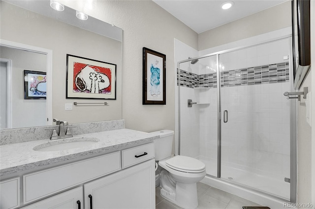 bathroom with tile patterned flooring, toilet, vanity, and a stall shower