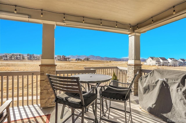 deck with grilling area, a mountain view, and a residential view